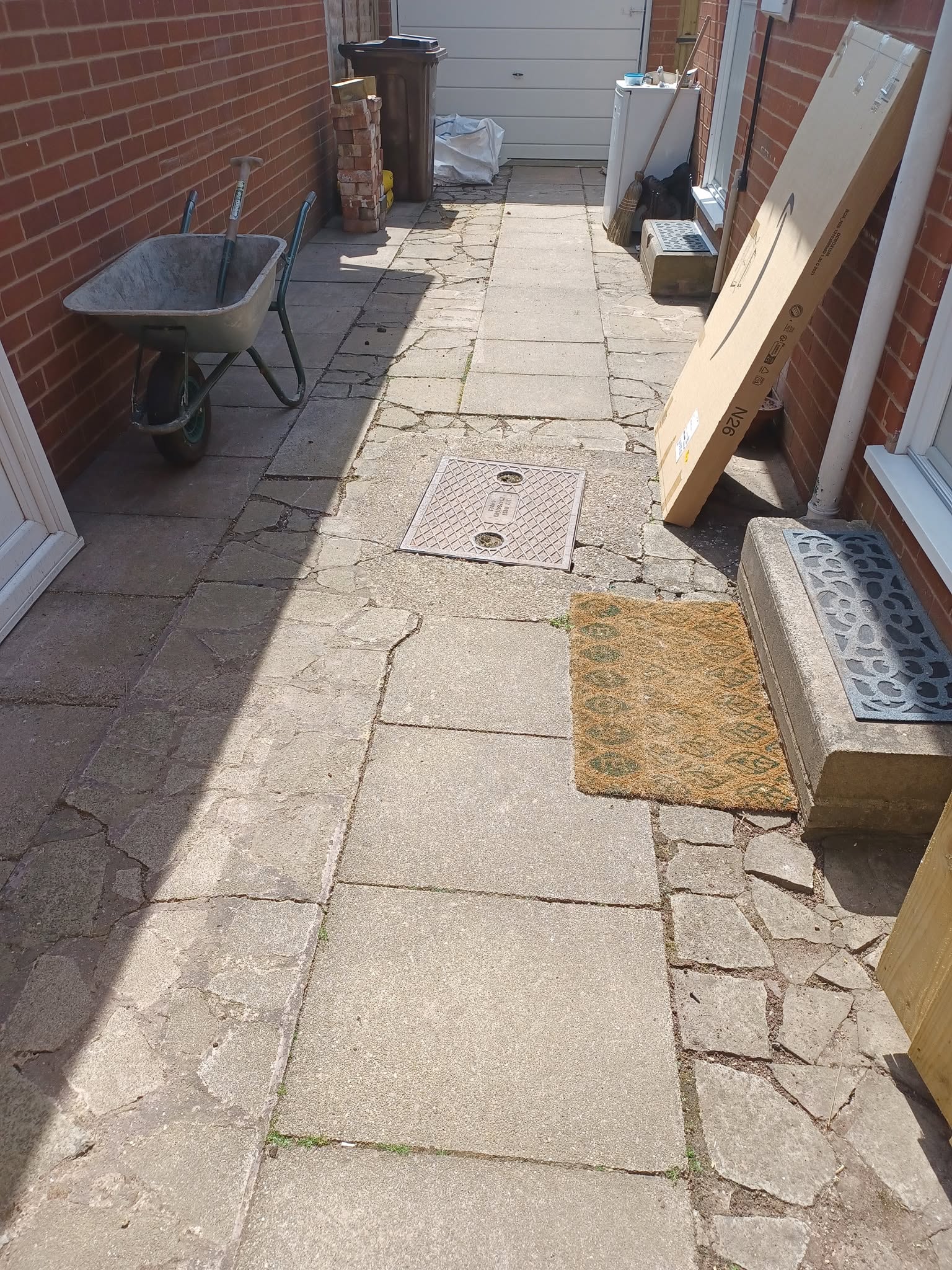 Cracked crazy paving down the side of the house before, Walton