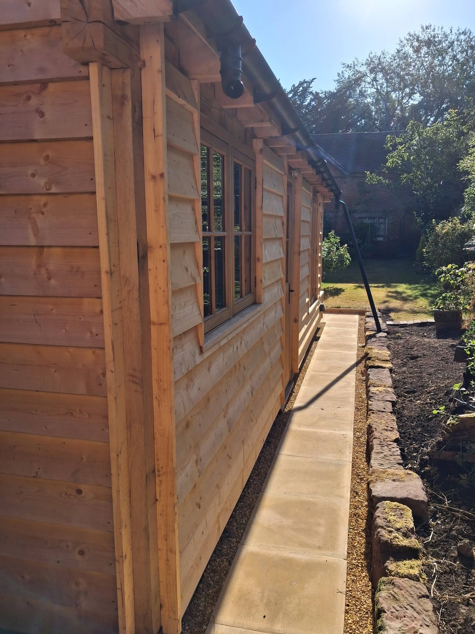Finished oak garage side elevation with new pathway