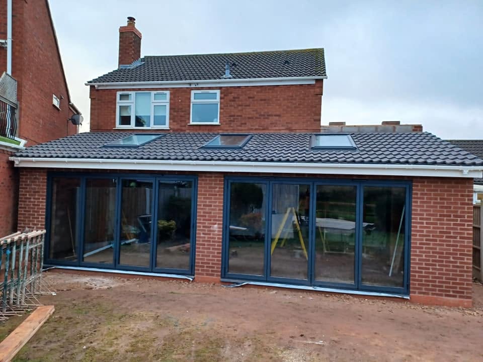 Finished extension shell with anthracite bi-fold doors, Stonnall